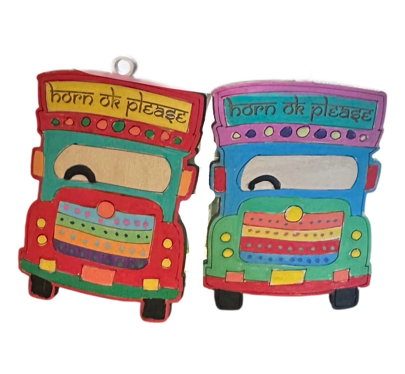Two colorful toy trucks with 'horn ok please' text on a white background