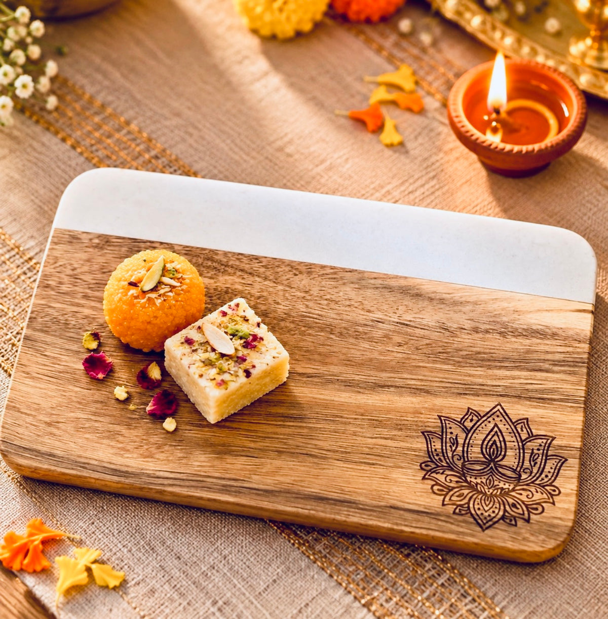 Diwali lotus diya board with mithai served in it 