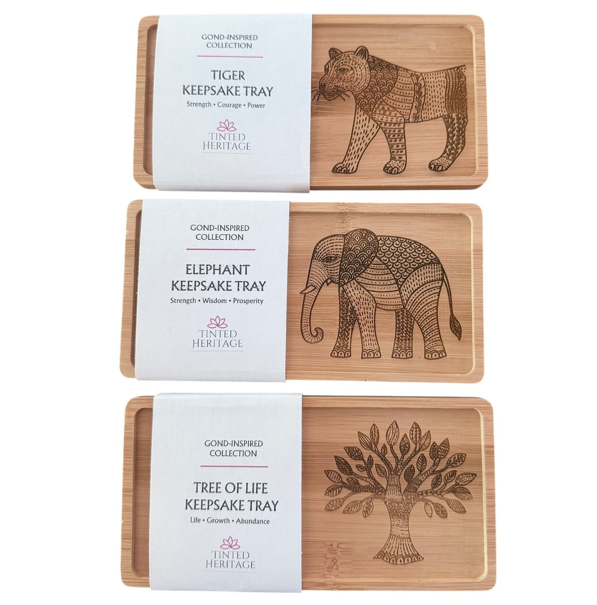 Three Gond-inspired bamboo keepsake trays featuring engraved Tree of Life, elephant and tiger designs by Tinted Heritage.